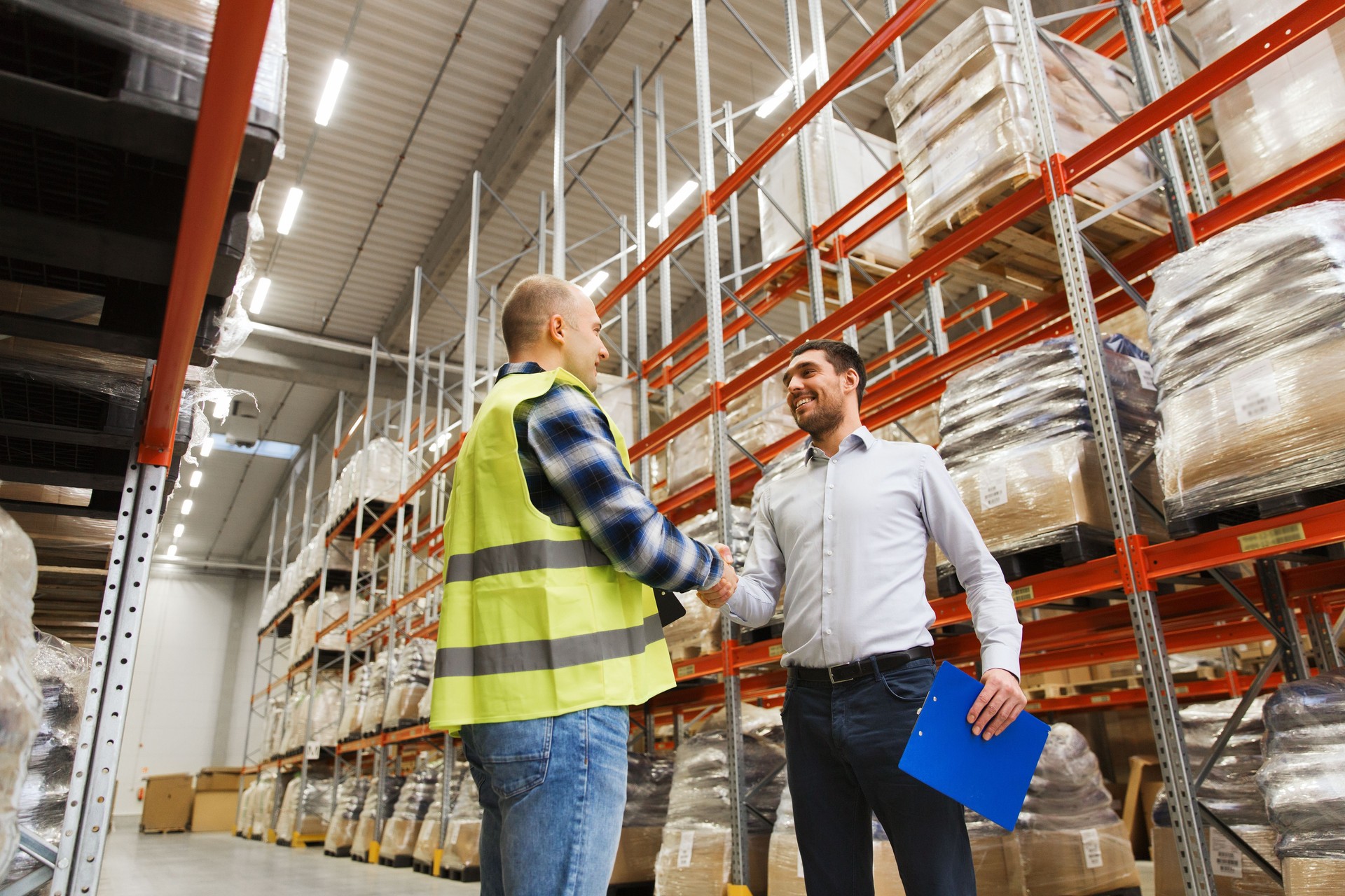 worker and businessmen with clipboard at warehouse